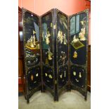 A Japanese black chinoiserie four fold dressing screen