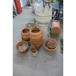 A crown top chimney pot and assorted terracotta plant pots