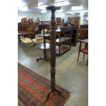 A Hepplewhite style carved mahogany torchere