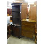 A mahogany freestanding corner cupboard and a mahogany chest of drawers