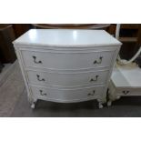 A French style cream and parcel gilt serpentine chest of drawers