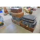 A banded trunk and six suitcases