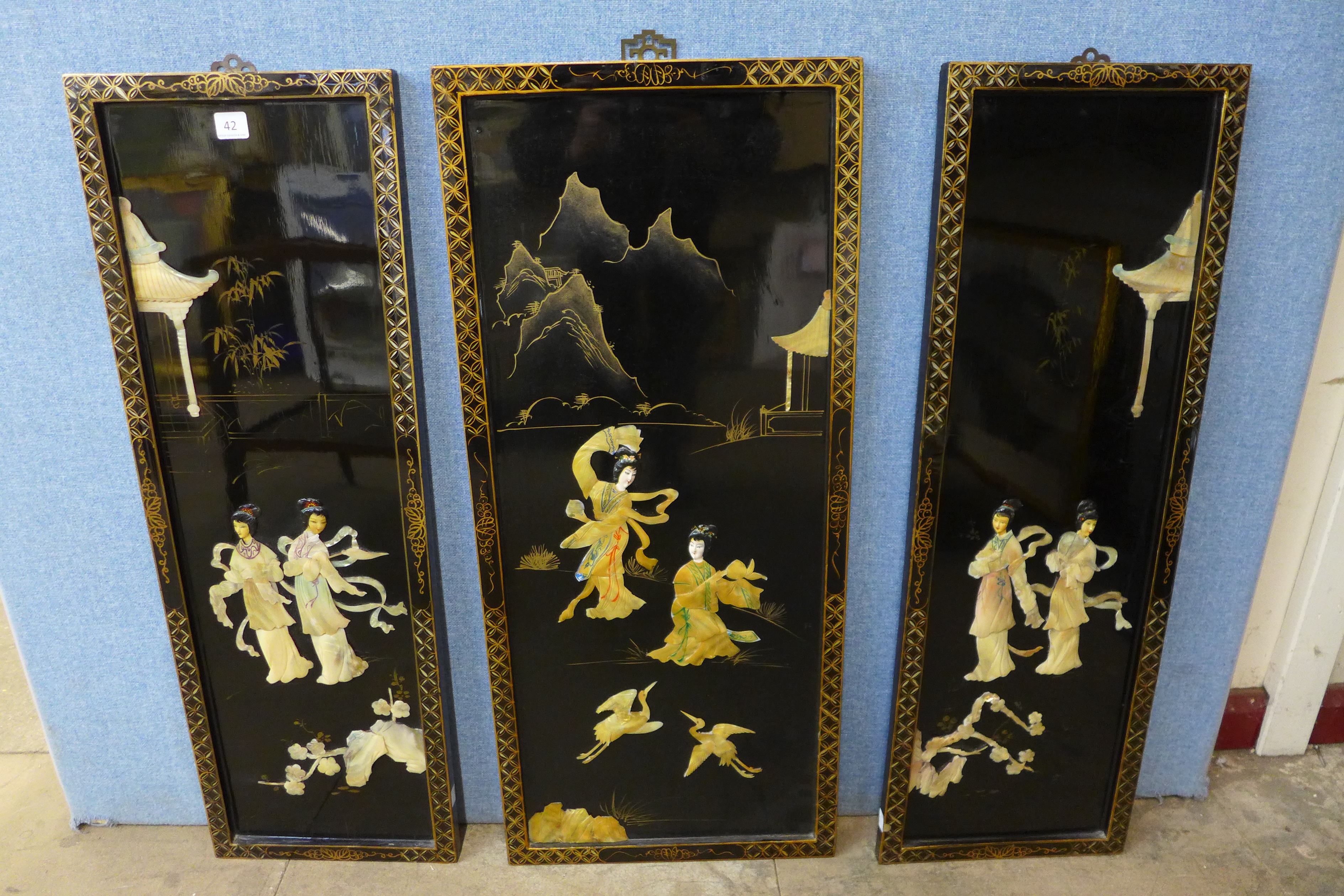 A pair of Chinese black chinoiserie panels and another