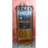 An Edward VII Sheraton Revival mahogany and marquetry inlaid serpentine display cabinet