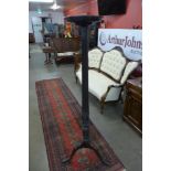A Hepplewhite style carved mahogany torchere