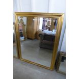 A large gilt framed bevelled mirror