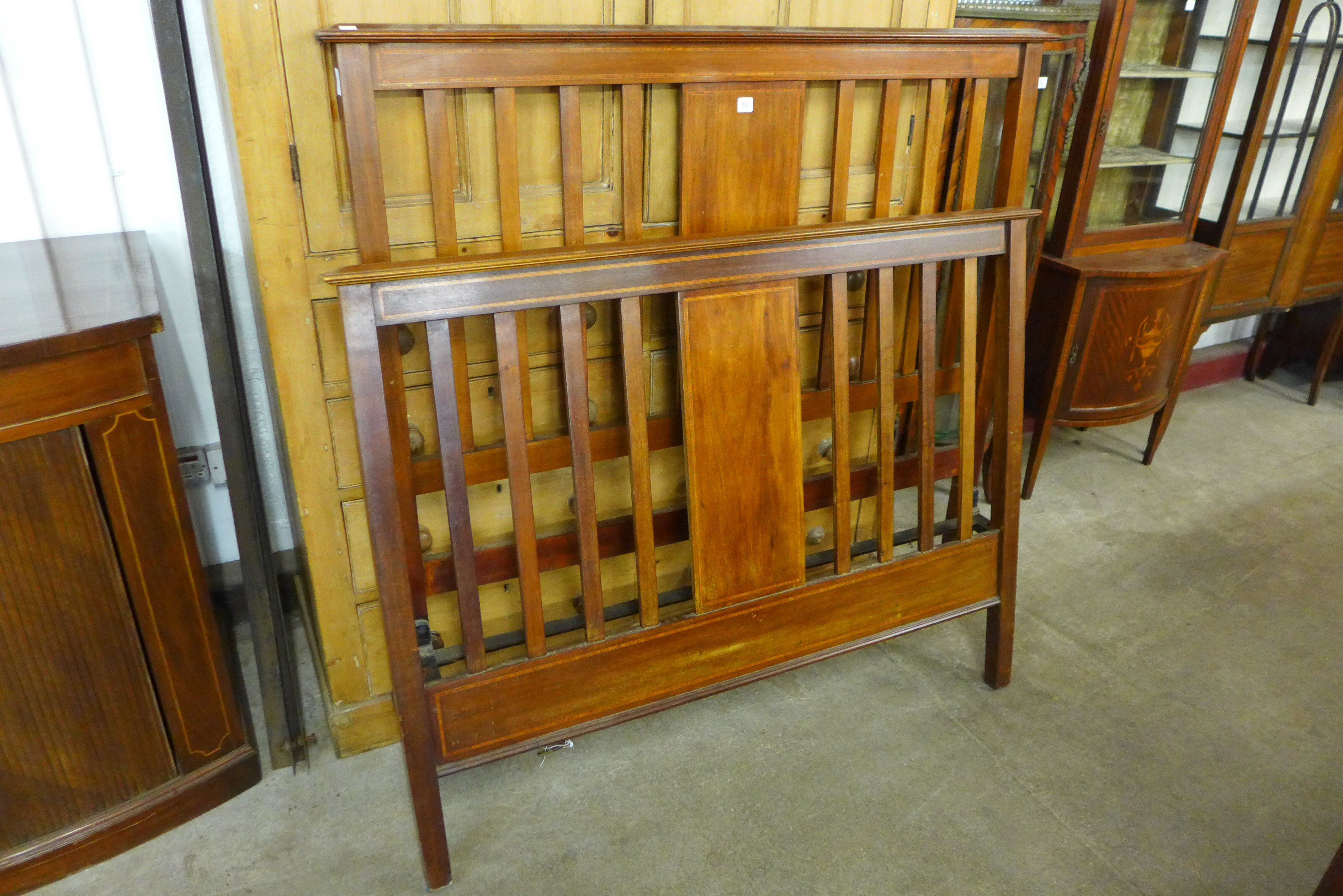 An Edward VII inlaid mahogany double bed