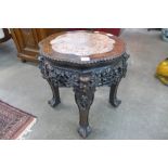 A Chinese carved padouk wood and marble topped jardiniere stand