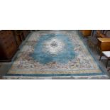 A large Chinese green ground rug,