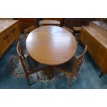 A teak drop-leaf dining table and four chairs