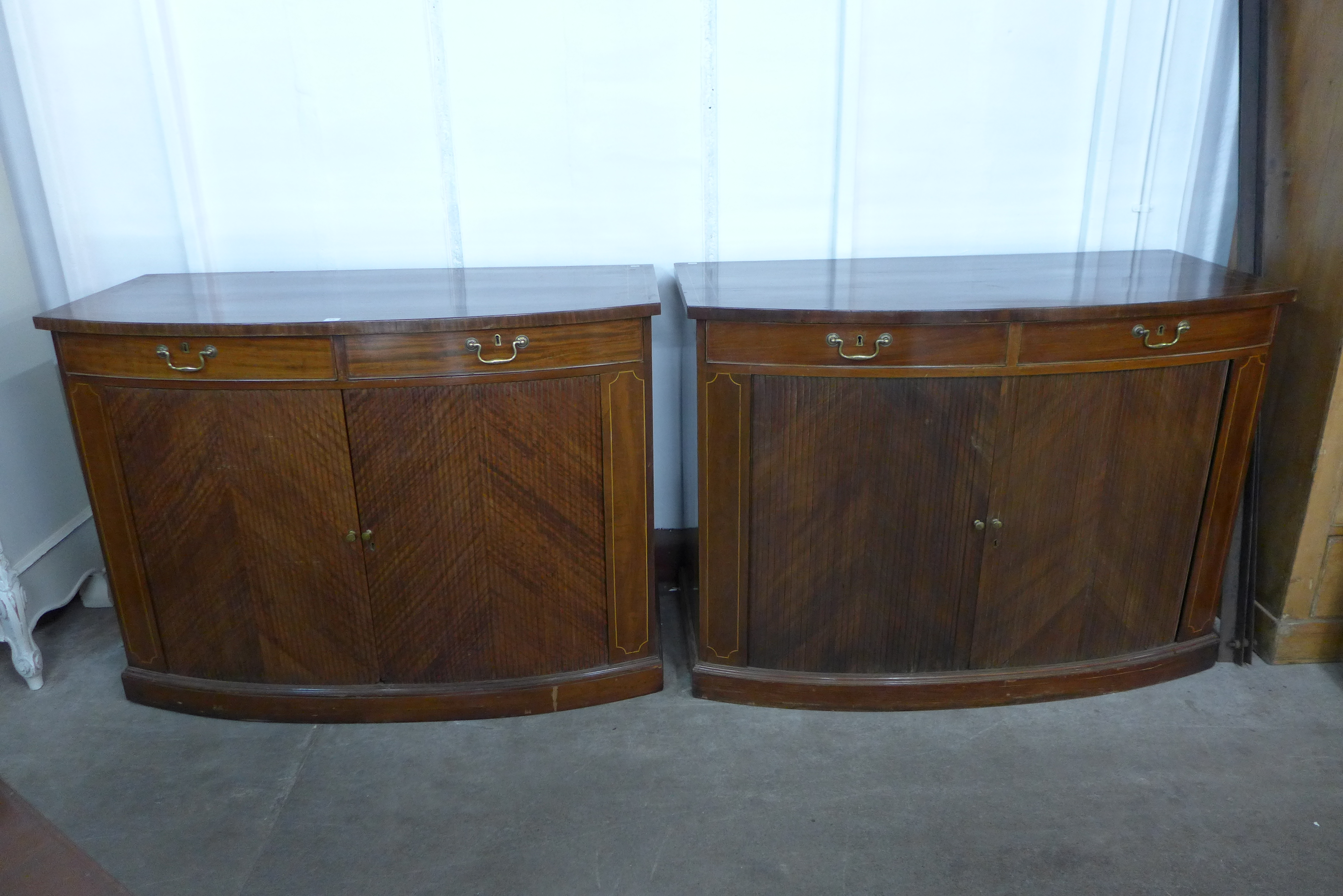 A pair of George III inlaid mahogany tambour front side cabinets