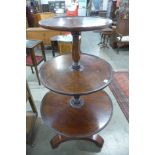 A George III mahogany three tier circular dumb waiter