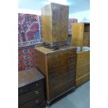 A walnut chest of drawers and bedside cupboard