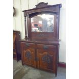 An Art Nouveau carved mahogany mirrorback sideboard