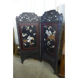 A carved chinoiserie two panel folding dressing screen