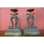 A pair of French bronze candle stands, made by F.