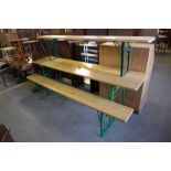 A German folding trestle table and two folding benches