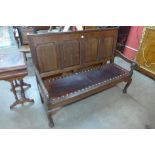 A George III oak panel back settle