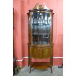 An Edward VII Sheraton Revival mahogany and marquetry inlaid serpentine display cabinet