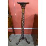 A Hepplewhite style carved mahogany torchere