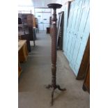 A Hepplewhite style carved mahogany torchere