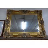 A large Victorian style gilt framed mirror