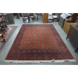 An Indian red ground rug,