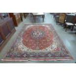 A Tabriz red ground rug,