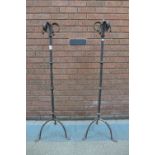 A pair of Gothic wrought iron candle stands