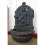 A continental cast iron wall mounted water feature