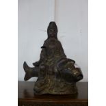 A large Chinese bronze figure of a deity and carp