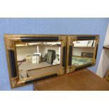 A pair of black and parcel gilt framed mirrors