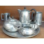 A Hall Brothers hammered pewter four piece tea service and tray and two pewter tankards