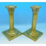 A pair of Georgian heavy brass Corinthian column candlesticks, 17.