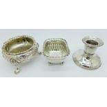 Two silver salts and a small silver candlestick,