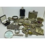 A large collection of silver plated items; hip flasks, wine funnel, magnifying glass, belts,