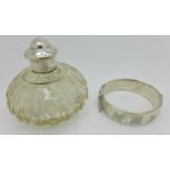 A white metal topped scent bottle and a silver bangle