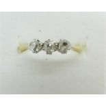 An 18ct gold, three stone diamond ring, 2.