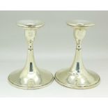 A pair of silver candlesticks, a/f, 13.