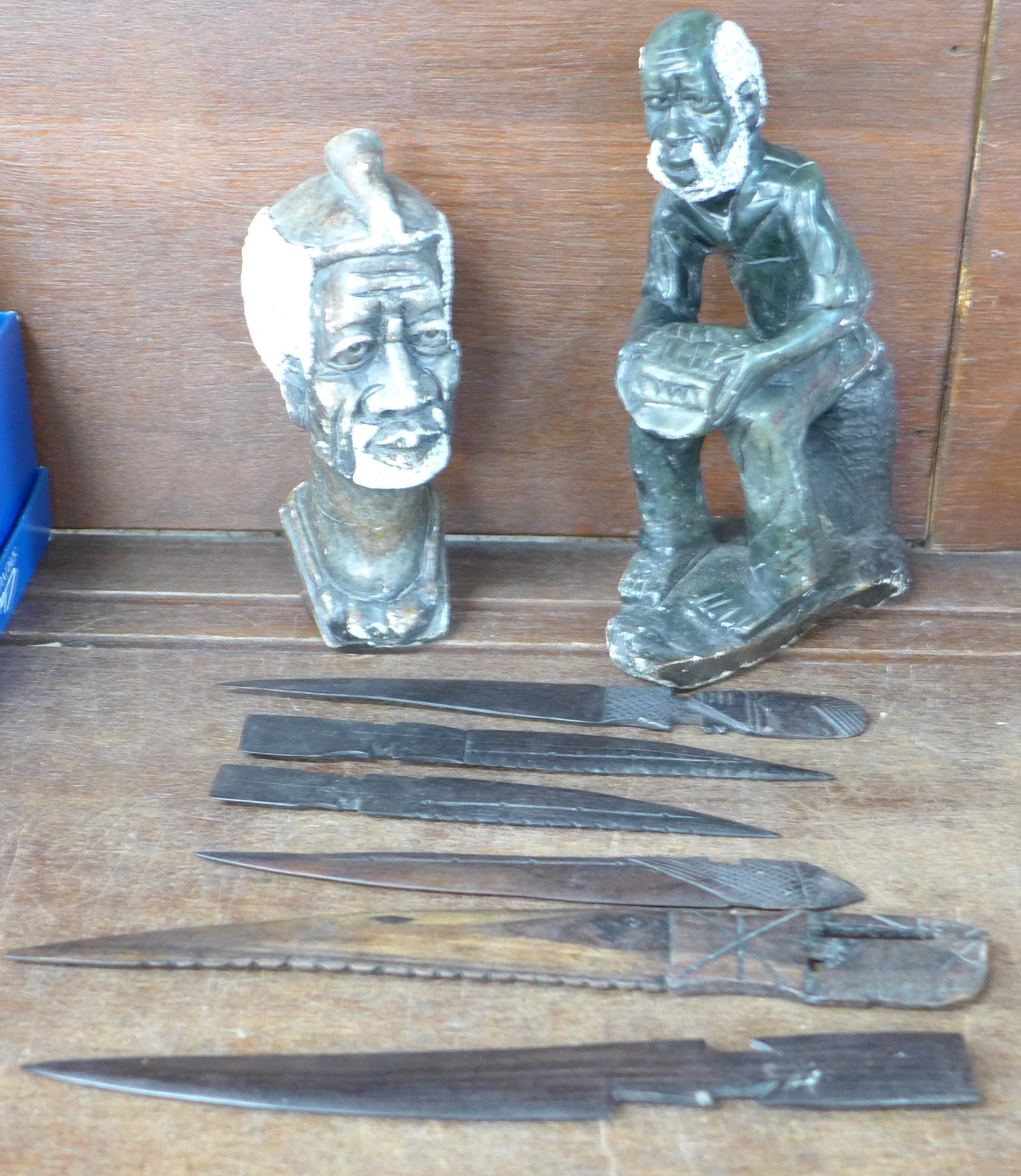 Two carved tribal figures and six carved hardwood letter openers