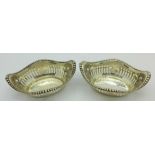 A pair of pierced silver dishes,