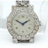 A diamond set, platinum cased cocktail wristwatch on a bracelet strap marked 9ct,