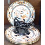 Four oriental decorated plates and a cow creamer,