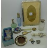 A collection of silver, a photograph frame, perfume bottles, an enamelled hand mirror,