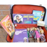 A suitcase containing Pippa dolls, annuals including The Man From U.N.C.L.E.