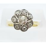 An 18ct gold, platinum and diamond Art Deco cluster ring, centre old cut diamond approximately 0.