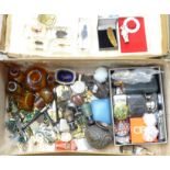 A suitcase containing plated ware, hip flasks, glassware, paperweights, rattle and teether, etc.