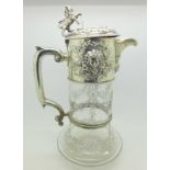 A Victorian silver and glass claret jug, the glass bears monogram,