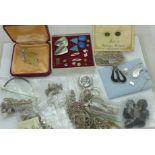 A collection of silver jewellery including rings, pendants, earrings, chains, etc.