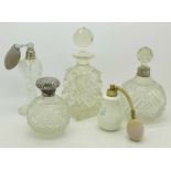 Five scent bottles including silver mounted and an oil pourer,